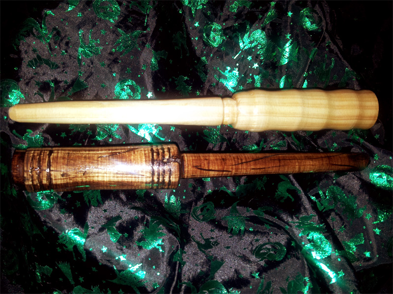 A 'clean' & smooth wand on top; A darker and battle scarred wand below.